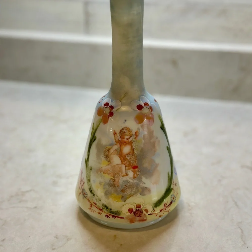 ANTIQUE BARBER SHOP BOTTLE WITH ATTRACTIVE CHERUB PICTURED ON FRONT SIDE.